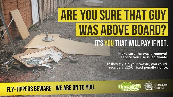 Fly-Tippers Beware Poster showing abandoned timber